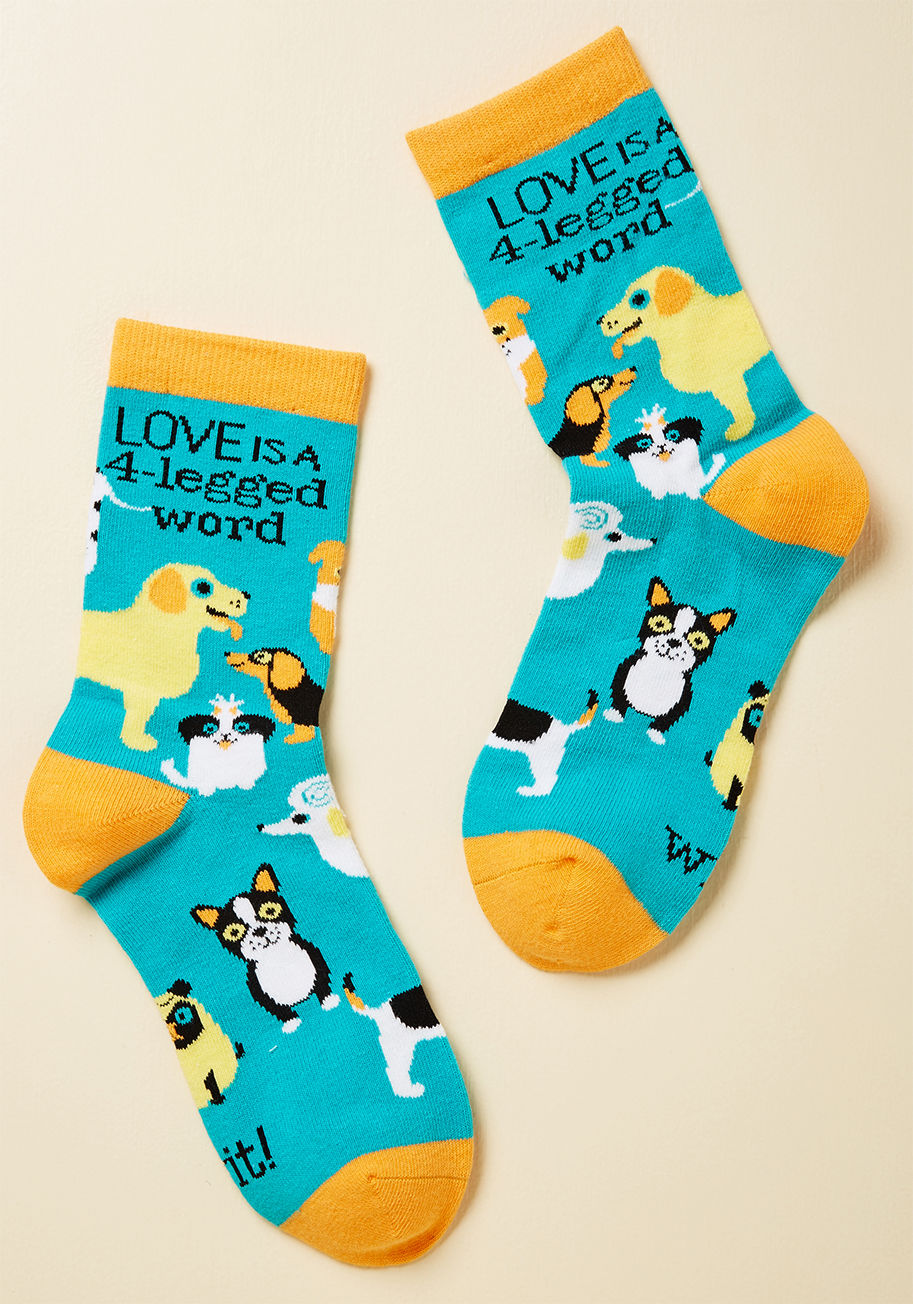 WT-1004-22 - It happens so fast - one day, you slip into these turquoise crew socks, and the next, you find yourself adopting a dog of your own. Go figure! With radiant orange trim and a pattern of wide-eyed pooches, these socks express your adoration for four-legged 