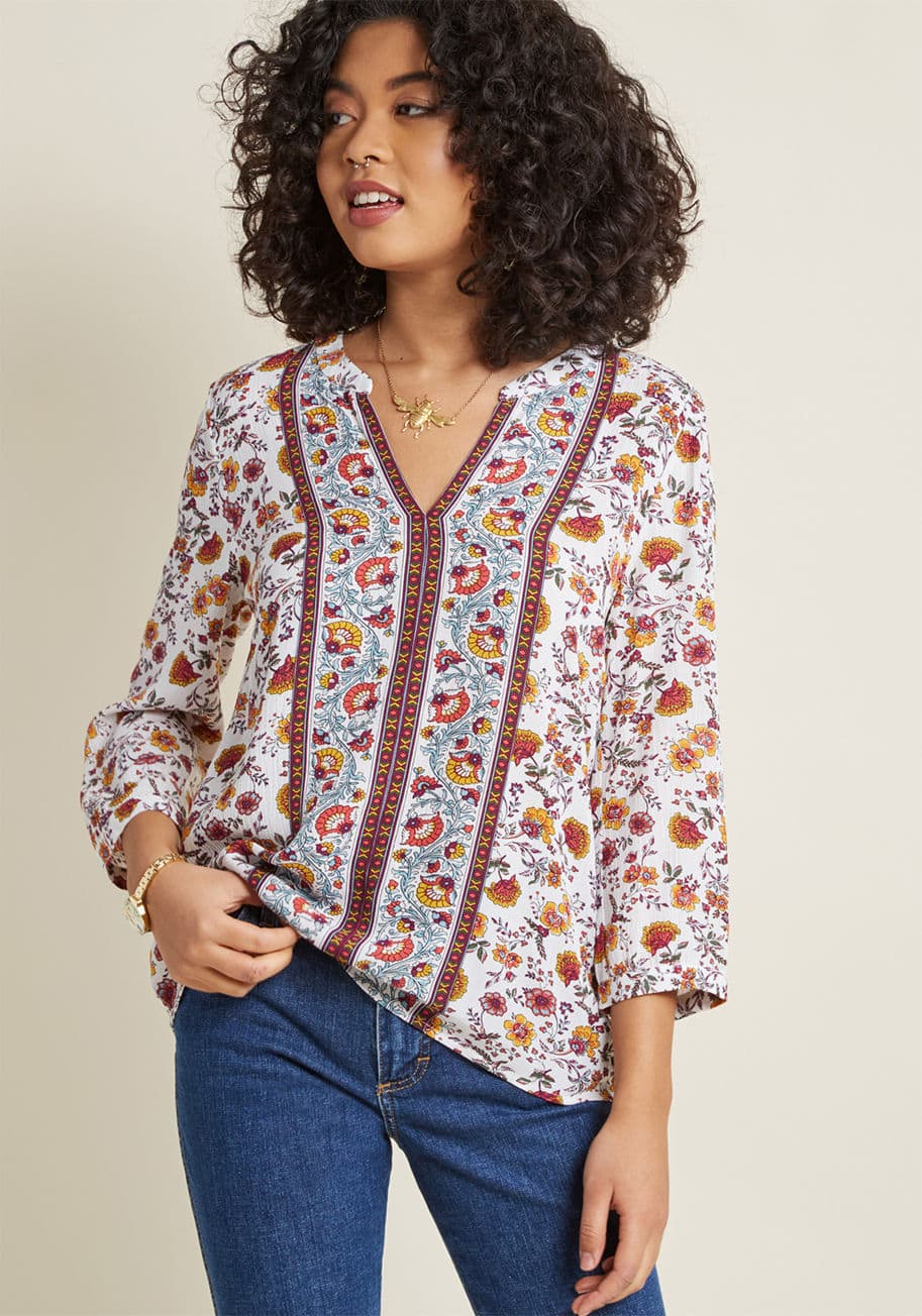 WT21564 - Hold true to your tradition of flaunting blouses with legendarily lovely details by donning this white top. This boho-inspired piece features warm-toned florals with geometric borders, and with a notched neckline and 3/4 sleeves, this ModCloth exclusive n