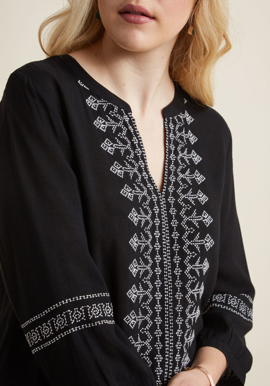 WT21654 - Hold true to your tradition of flaunting blouses with legendarily lovely details by donning this black top. This boho-inspired piece features white embroidery down its bodice and around the elbows, and with a notched neckline and 3/4 sleeves, this ModClot